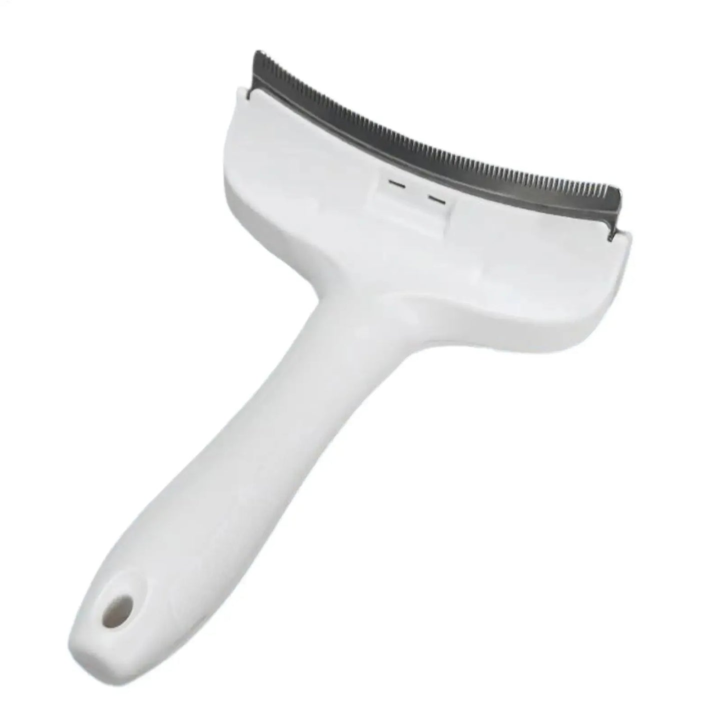 Deshedding brush held in hand for scale